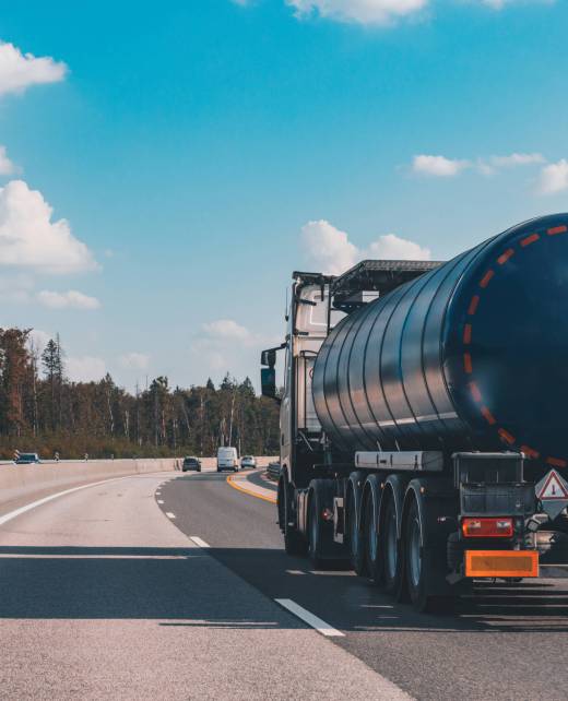 Fuel tanker truck on the highway asphalt road on fall autumn day