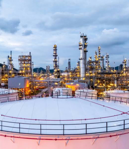 Oil refinery petrochemical plant at dusk illuminated storage tank industrial infrastructure, Oil refinery petrochemical product storage tank at oil refinery factory industry, Global energy refinery.