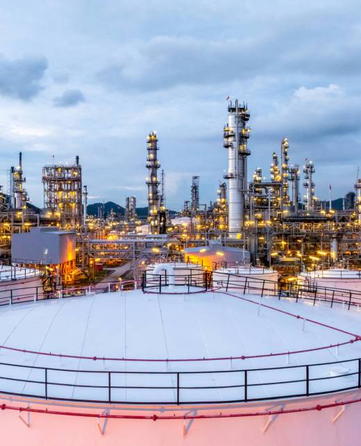 Oil refinery petrochemical plant at dusk illuminated storage tank industrial infrastructure, Oil refinery petrochemical product storage tank at oil refinery factory industry, Global energy refinery.